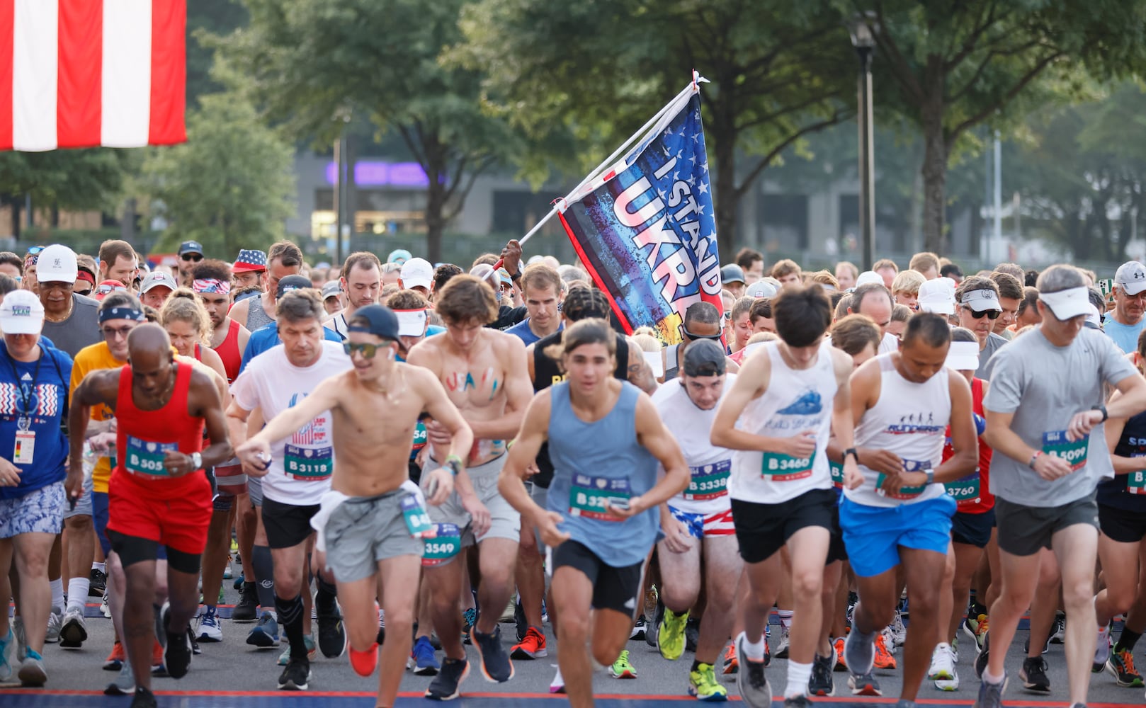 Runners take off at start of the 53rd running of the Atlanta Journal-Constitution Peachtree Road Race in Atlanta on Monday, July 4, 2022. (Miguel Martinez / Miguel.MartinezJimenez@ajc.com)