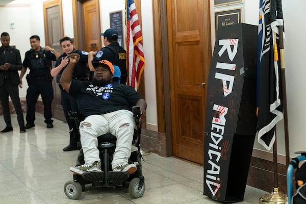 A demonstrator on wheelchair protests outside the office of Sen. Bill Cassidy, R-La., on the proposed cuts to Medicaid on Capitol Hill, in Washington, Wednesday, June 11, 2025. (AP Photo/Jose Luis Magana)