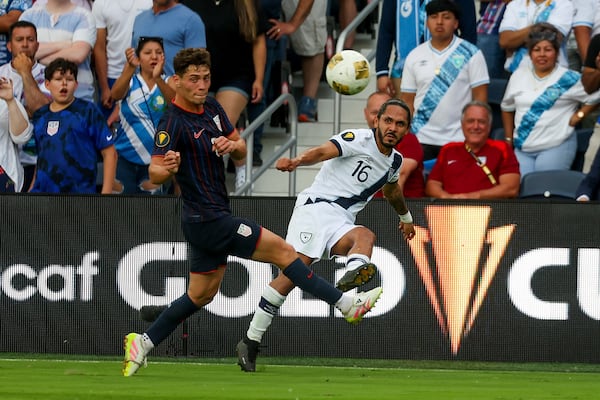 Guatemala defender Jose Morales (16) clears the ball while under pressure from United States midfielder Sebastian Berhalter, left, during the first half of a CONCACAF Gold Cup semifinal soccer match, Wednesday, July 2, 2025, in St. Louis. (AP Photo/Scott Kane)