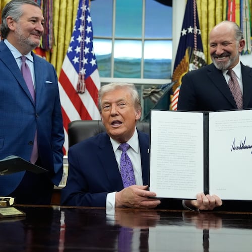 FILE - Flanked by Sen. Ted Cruz, R-Texas, left, Secretary of Commerce Howard Lutnick, second right, and White House AI and Crypto Czar David Sacks, President Donald Trump displays his signed AI initiative in the Oval Office of the White House, Dec. 11, 2025, in Washington. (AP Photo/Alex Brandon, File)