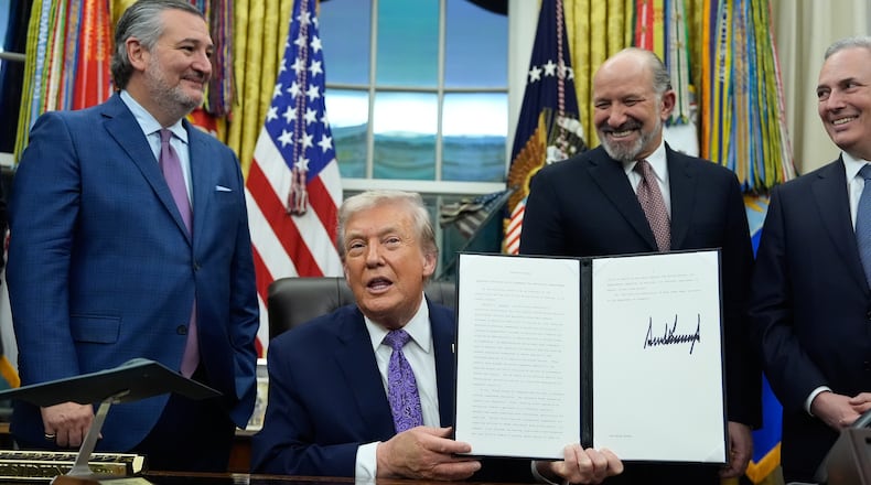 FILE - Flanked by Sen. Ted Cruz, R-Texas, left, Secretary of Commerce Howard Lutnick, second right, and White House AI and Crypto Czar David Sacks, President Donald Trump displays his signed AI initiative in the Oval Office of the White House, Dec. 11, 2025, in Washington. (AP Photo/Alex Brandon, File)