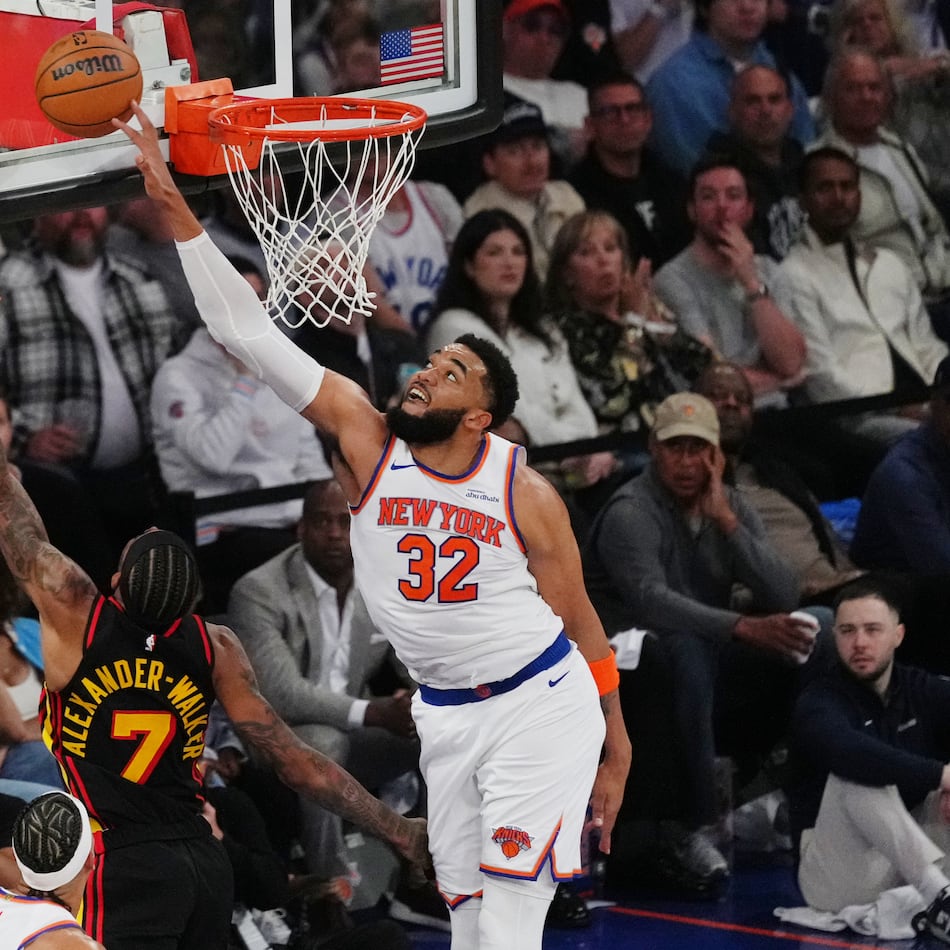 New York Knicks' Karl-Anthony Towns (32) blocks a shot by Atlanta Hawks' Nickeil Alexander-Walker (7) during the first half in Game 1 of a first-round NBA playoffs basketball series, Saturday, April 18, 2026, in New York. (AP Photo/Frank Franklin II)