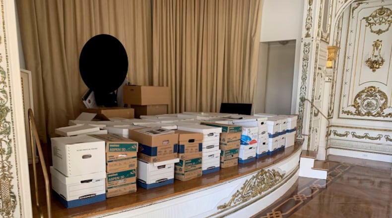 This image, contained in the indictment against former President Donald Trump, and partially redacted by source, shows boxes of records being stored on the stage in the White and Gold Ballroom at Trump's Mar-a-Lago estate in Palm Beach, Fla. (Justice Department via AP)