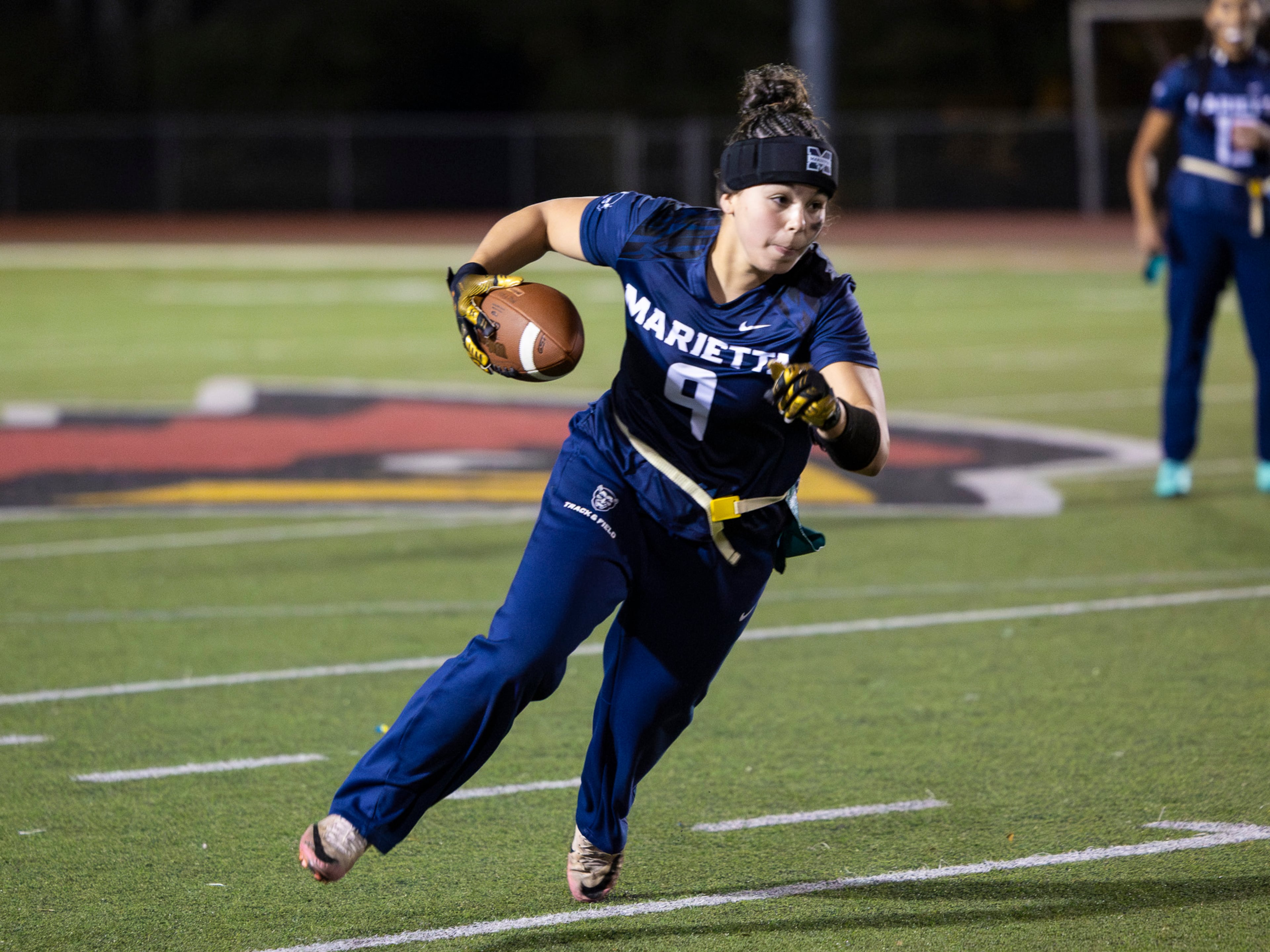 Marietta's Lylah Campos (9) runs with the ball in a flag football game against McEachern at Osborne High School in Marietta, GA on Monday, November 17th, 2025. (Oscar Guevara Saenz for the AJC)