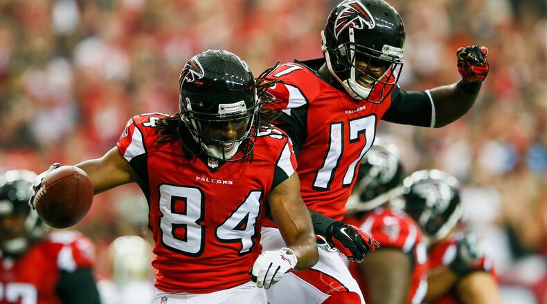 Roddy White #84 celebrates with Devin Hester #17 of the Atlanta Falcons after a touchdown catch in the first half against the New Orleans Saints at the Georgia Dome on September 7, 2014 in Atlanta, Georgia.