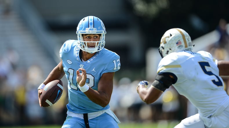 North Carolina quarterback Chazz Surratt (12) runs against Georgia Tech defensive back A.J. Gray (5) during the first half of an NCAA college football game, Saturday, Sept. 30, 2017, in Atlanta. (AP Photo/Jon Barash)