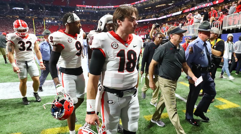 Georgia quarterback JT Daniels and head coach Kirby Smart walk off the field after the 41-24 loss to Alabama in the SEC championship game.