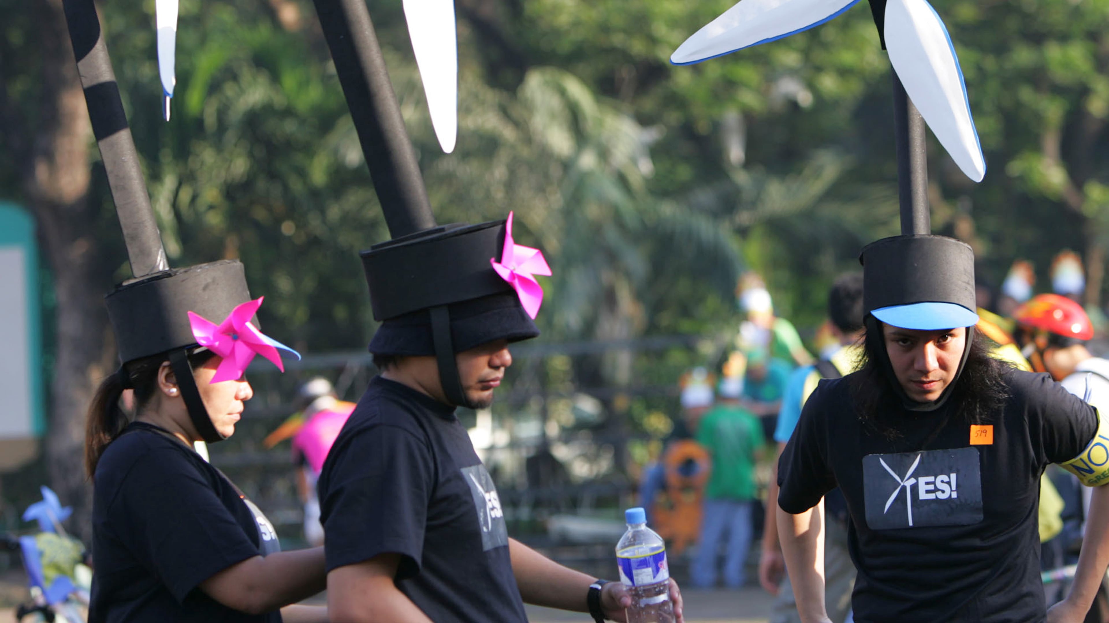 FILE -Participants wear wind turbine headgear to raise peoples awareness on renewable energy, fix their costumes during the Global Day of Action Against Climate Change ,Dec. 8, 2007 in suburban Quezon City, north of Manila, Philippines. (AP Photo/Pat Roque, File)