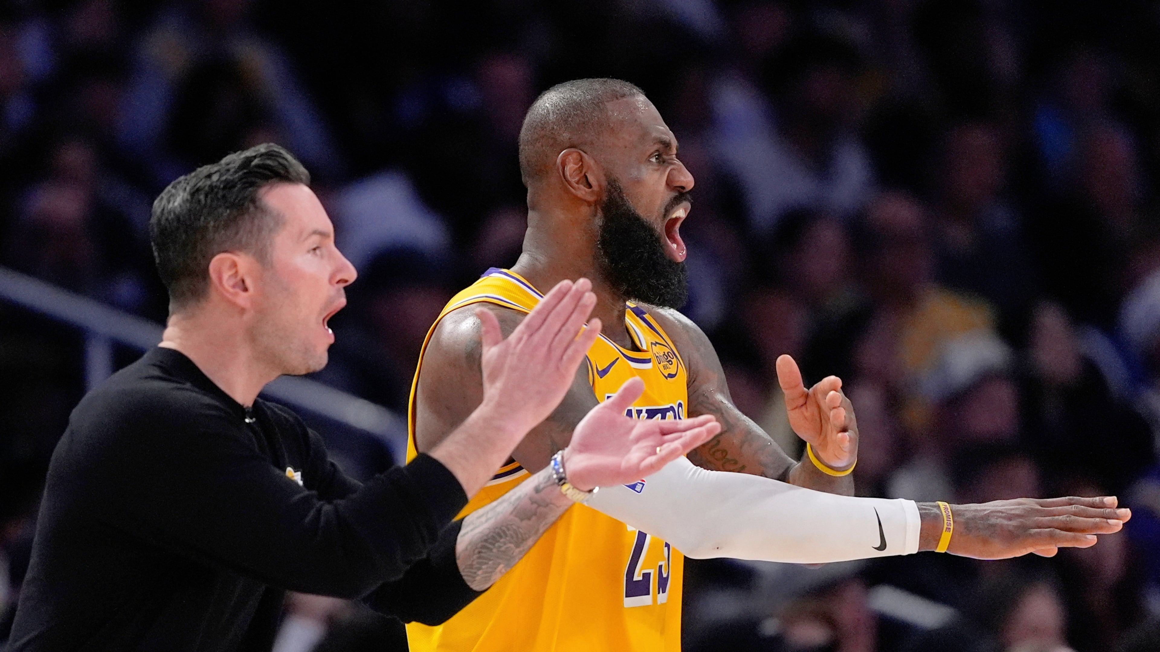 FILE - Los Angeles Lakers head coach JJ Redick, left, and forward LeBron James yell to the referees during the second half of an NBA basketball game against the Golden State Warriors Thursday, April 3, 2025, in Los Angeles. (AP Photo/Mark J. Terrill, File)