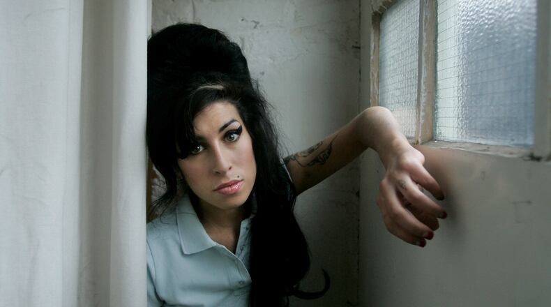 FILE - British singer Amy Winehouse poses for photographs after being interviewed by The Associated Press at a studio in north London, Friday, Feb. 16, 2007. (AP Photo/Matt Dunham, File)