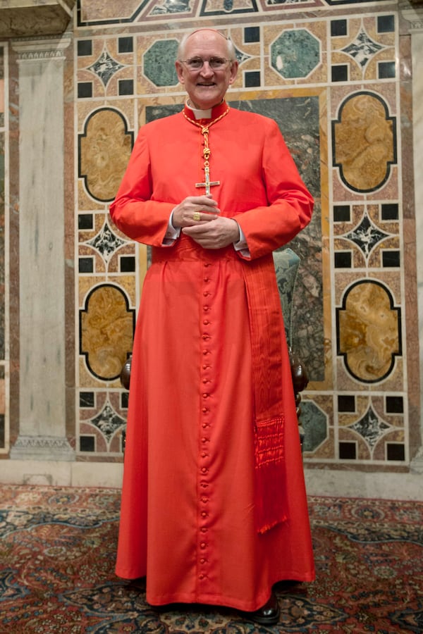 FILE - Newly-elected Cardinal James Michael Harvey from the U.S. poses for photographers prior to meeting relatives and friends after he was elevated to cardinal by Pope Benedict XVI, at the Vatican during a consistory, Nov. 24, 2012. (AP Photo/Andrew Medichini, File)