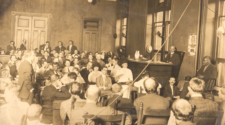 This photo shows prosecutor Hugh Dorsey, standing at left during the trial of Leo Frank, who is seated at center. This photo from the Frank trial was shot by Walter Winn in 1913. Winn's grandson, Walter Winn of Decatur, said this image and many others from Winn's career have been handed down to succeeding generations of the family.