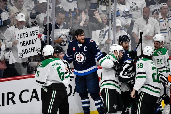 Winnipeg Jets' Adam Lowry (17) and Dallas Stars players push and shove at the end of a play during third period NHL playoff hockey action in Winnipeg, Thursday, May 15, 2025. (Fred Greenslade/The Canadian Press via AP)
