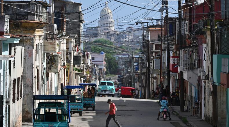 A man crosses a street in Havana, Monday, May 25, 2026. (AP Photo/Jorge Luis Banos)