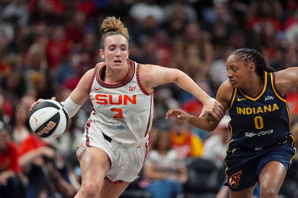 Connecticut Sun guard Marina Mabrey (3) drives on Indiana Fever guard Kelsey Mitchell (0) in the first half of a WNBA basketball game in Indianapolis, Tuesday, June 17, 2025. (AP Photo/Michael Conroy)