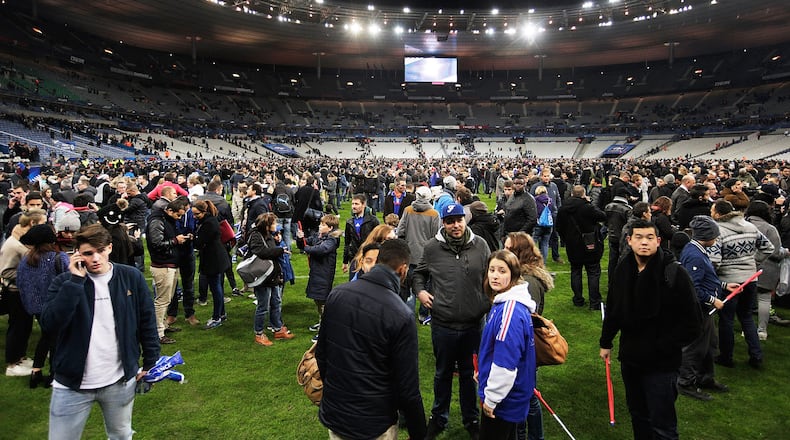Spectators gather on the pitch after news of the bombing and terrorist attacks in Paris reaches the fans after the International Friendly match between France and Germany at the Stade de France on November 13, 2015 in Paris, France. (Photo by Adam Pretty/Bongarts/Getty Images)