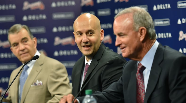 Braves president of baseball operations John Hart (right) and vice chairman John Schuerholz (left) flank former general manager John Coppolella at the October 2015 news conference to announce Coppolella’s promotion to GM. He was forced to resign two years later. (Hyosub Shin/hshin@ajc.com)