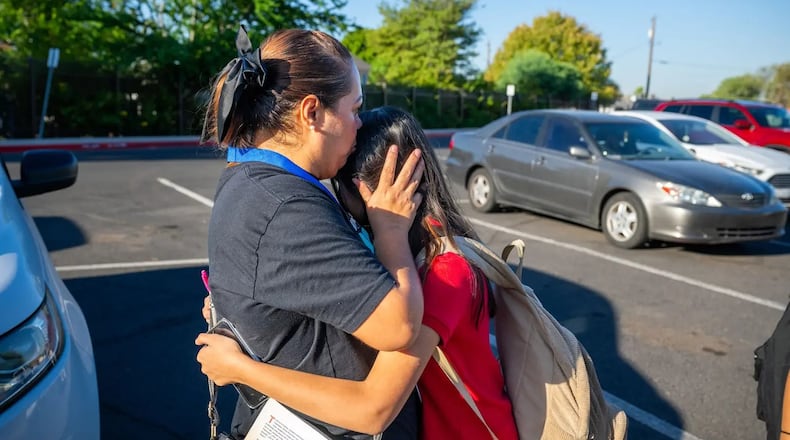 Angelica Zavala embraces her daughter, whom she considered sending to a private school. (Courtesy of Ash Ponders / ProPublica)