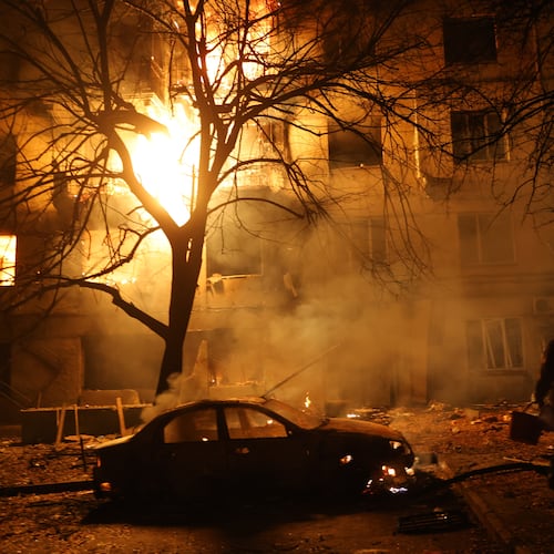 A man walks in front of burning residential building after a Russian attack on Zaporizhzhia, Ukraine, Wednesday, Nov. 26, 2025. (AP Photo/Kateryna Klochko)