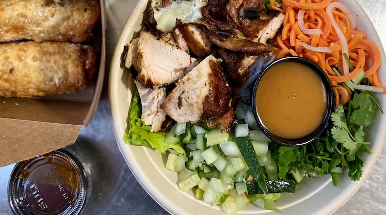 A takeout feast from Pho Cue includes loaded fries dressed up with banh mi toppings, dumplings filled with pork cue, a vermicelli salad with smoked chicken, and insanely good egg rolls with brisket.
Wendell Brock for The Atlanta Journal-Constitution