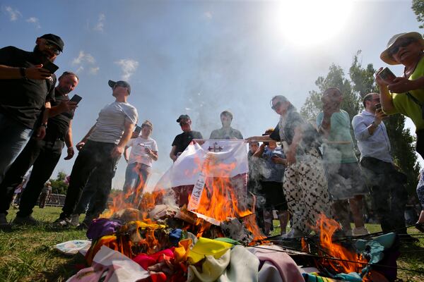 FILE - Opponents of gay rights burn LGBTQ+ flags to counter a pride event in Tbilisi, Georgia, on July 8, 2023. (AP Photo/Zurab Tsertsvadze, File)