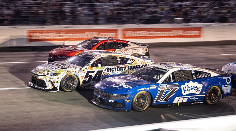 Roush Fenway Keselowski Racing driver Chris Buescher (17) and Joe Gibbs Racing driver Ty Gibbs (54) battle in turn one during Cook Out 400 at Richmond Raceway, Saturday, Aug. 15, 2026, in Richmond Va. (AP Photo/Robert Simmons)