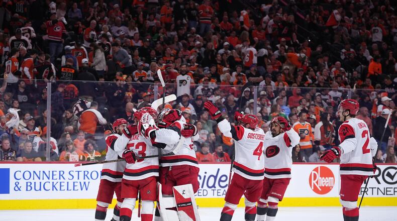 Carolina Hurricanes' players celebrate after winning Game 4 against the Philadelphia Flyers in a second-round NHL hockey Stanley Cup playoff series Saturday, May 9, 2026, in Philadelphia. (AP Photo/Matt Slocum)
