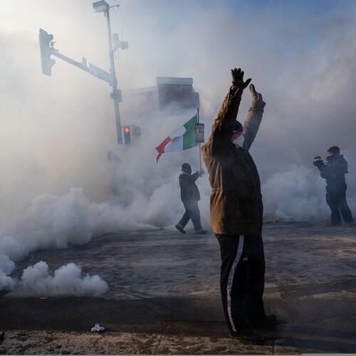 A person holds up their hands as law enforcement deploys a thick screen of teargas on Nicollet Avenue in Minneapolis on Saturday, Jan. 24, 2026. (Ben Hovland/Minnesota Public Radio via AP)