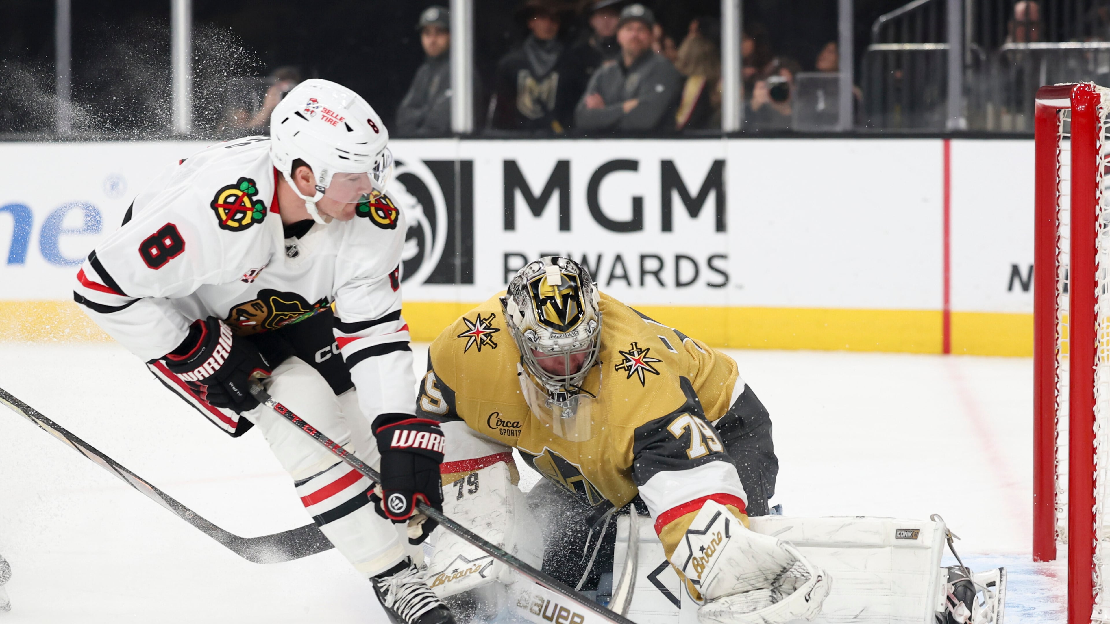 Vegas Golden Knights goaltender Carter Hart (79) stops a shot from Chicago Blackhawks center Ryan Donato (8) during the first period of an NHL hockey game Tuesday, Dec. 2, 2025, in Las Vegas. (AP Photo/Ian Maule)