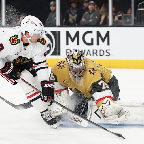 Vegas Golden Knights goaltender Carter Hart (79) stops a shot from Chicago Blackhawks center Ryan Donato (8) during the first period of an NHL hockey game Tuesday, Dec. 2, 2025, in Las Vegas. (AP Photo/Ian Maule)