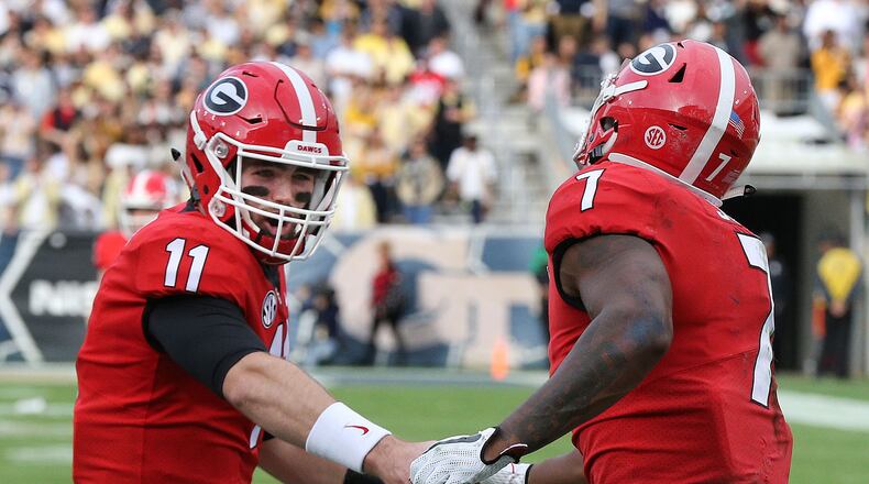 November 25, 2017 Atlanta: Georgia quarterback Jake Fromm gives running back Dââ¬â¢Andre Swift five after he went over the top for a touchdown to take a 31-7 lead over Georgia Tech during the third quarter in a NCAA college football game on Saturday, November 25, 2017, in Atlanta. Curtis Compton/ccompton@ajc.com