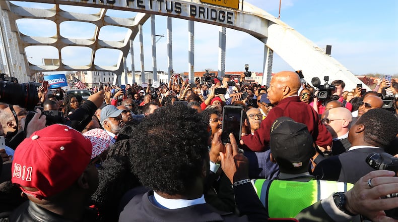A group of men hoist U.S. Rep. John Lewis, D-Atlanta, on their shoulders so he can speak to the crowd of marchers at the Edmund Pettus Bridge during Selma's re-enactment of Bloody Sunday on Sunday, March 1, 2020, in Selma. Curtis Compton ccompton@ajc.com