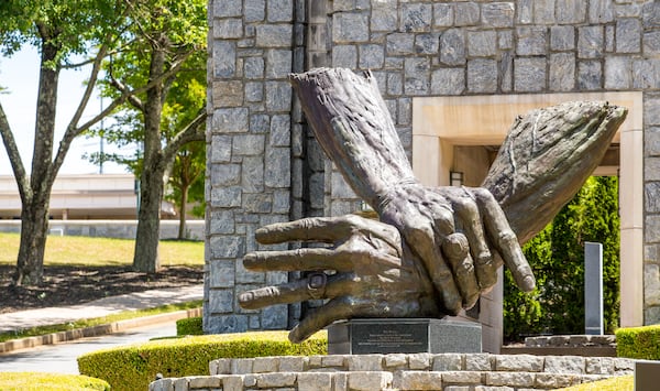 At Marietta's Life University, the nation's largest chiropractic school, a traditional, philosophy-based form of chiropractic dominates. This campus sculpture is of the hands of founder Sid Williams. (Jenni Girtman for the AJC)