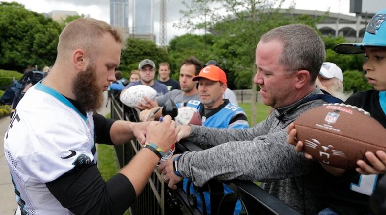 Carolina Panthers' Ben Boulware, left, signs autographs after practice during the NFL football team's rookie camp in Charlotte, N.C., Friday, May 5, 2017. (AP Photo/Chuck Burton)