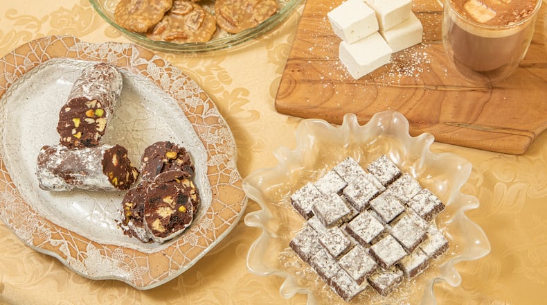 Homemade candy is a delicious holiday and hostess gift. These recipes from Julie Frazier, owner of Maybird Confections, are as easy to make as a batch of cookies. Clockwise from left: Chocolate Salami, Pecan Pralines, Baileys Irish Cream Liqueur Marshmallows and Chocolate Mint Meltaways. (Styling by Julie Frazier / Aaliyah Man for The Atlanta Journal-Constitution)