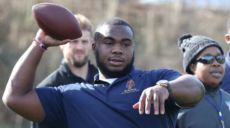 Atlanta- Atlanta Falcons defensive tackle Grady Jarrett throws a pass to students during the Walter Payton NFL Man of the Year Community Event at the Warren Boys & Girls Club on Friday, Feb. 1, 2019, in Atlanta. Considered the league's most prestigious honor, nominated players participated in activities, beautification projects, and building a new playground. Curtis Compton/ccompton@ajc.com