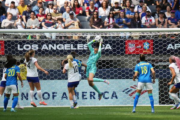 United States goalkeeper Phallon Tullis-Joyce (21) makes a save against Brazil defender Tarciane (3) during the first half of a women's international friendly soccer match in Inglewood, Calif. Saturday, April 5, 2025. (AP Photo/Jae C. Hong)
