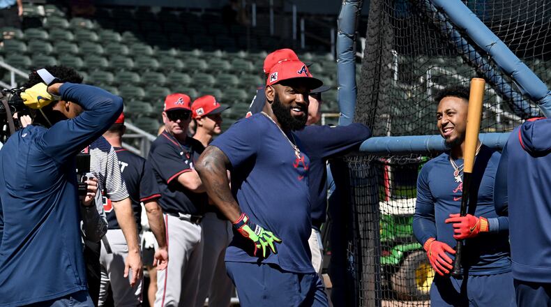 Atlanta Braves designated hitter Marcell Ozuna (center) reacts as he talks with outfielder Ronald Acuna Jr. (left) and  second base Ozzie Albies (right) during spring training workouts at CoolToday Park, Monday, February 17, 2025, North Port, Florida. (Hyosub Shin / AJC)