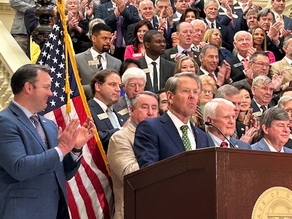 Gov. Brian Kemp and legislative leaders celebreated the approval of a legislation rebating income taxes and suspending the gas tax on Friday. (David Wickert/AJC)