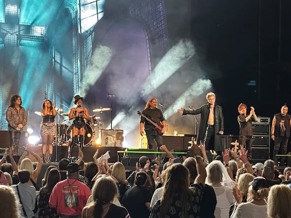 Billy Idol introduces his band at the very end of the concert at Ameris Bank Amphitheatre and gave final kudos to Steve Stevens, his lead guitarist. (Rodney Ho/AJC)