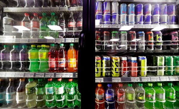 FILE - Soft drinks fill a drink cooler in a convenience store in Kent, Wash., Oct. 1, 2018. (AP Photo/Elaine Thompson, File)