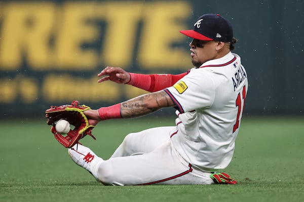 Atlanta Braves shortstop Orlando Arcia (11) attempts to make a sliding stop in the eighth inning of a baseball game against the St. Louis Cardinals, Tuesday, April 22, 2025, in Atlanta. (AP Photo/Colin Hubbard)