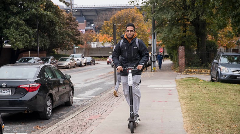A man rides a Bird Scooter on Georgia Tech's campus in Atlanta.