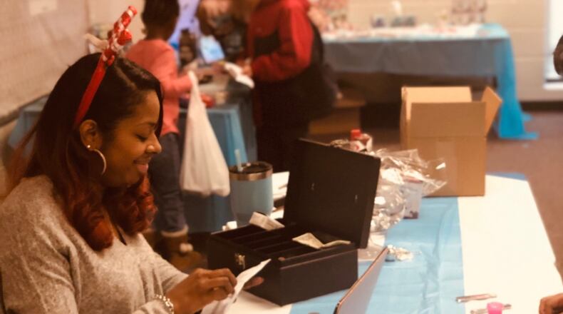 Meshana Spivey, president of the Magill Elementary PTA helps out during a winter fundraiser holiday store called the Peguin Patch. Spivey was named by the Georgia Department of Education and the Georgia PTA as an outstanding parent volunteer. CONTRIBUTED