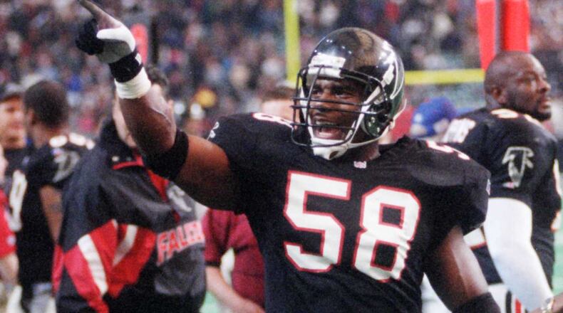 Falcons linebacker Jessie Tuggle points to the crowd in a 1995 game after coming up with a huge interception to seal a victory and keep the Falcons’ playoff hopes alive. (AJC file photo/Jonathan Newton)