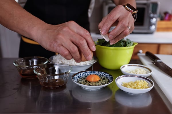 Gather the oils, egg, rice, cooking wine, salt and pepper. Slice the collard greens and mince the garlic and ginger. (Natrice Miller/AJC)