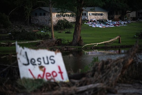 Camper's belongings sit outside one of Camp Mystic's cabins near the Guadalupe River after a flash flood swept through the area Monday, July 7, 2025, in Hunt, Texas. (AP Photo/Eli Hartman)