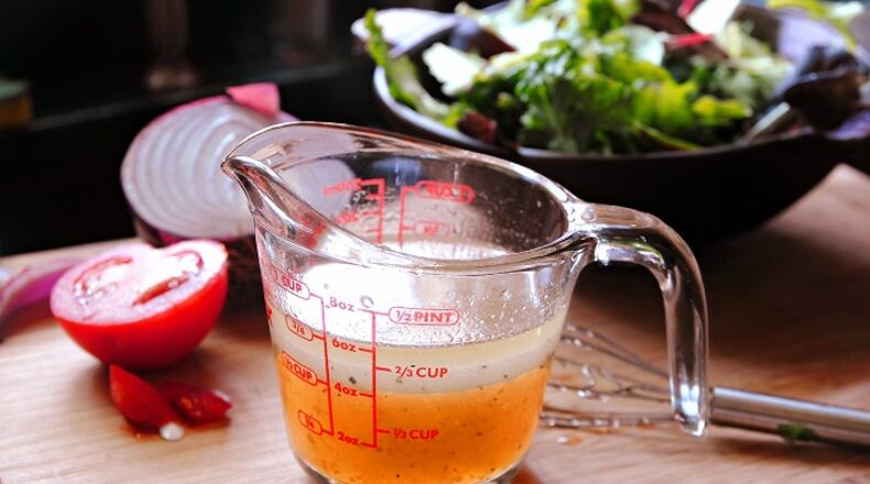 The right blend of oil, vinegar and spices can elevate a simple bowl of greens, including this Pepper Jelly Vinaigrette. (Gretchen McKay/Pittsburgh Post-Gazette/TNS)