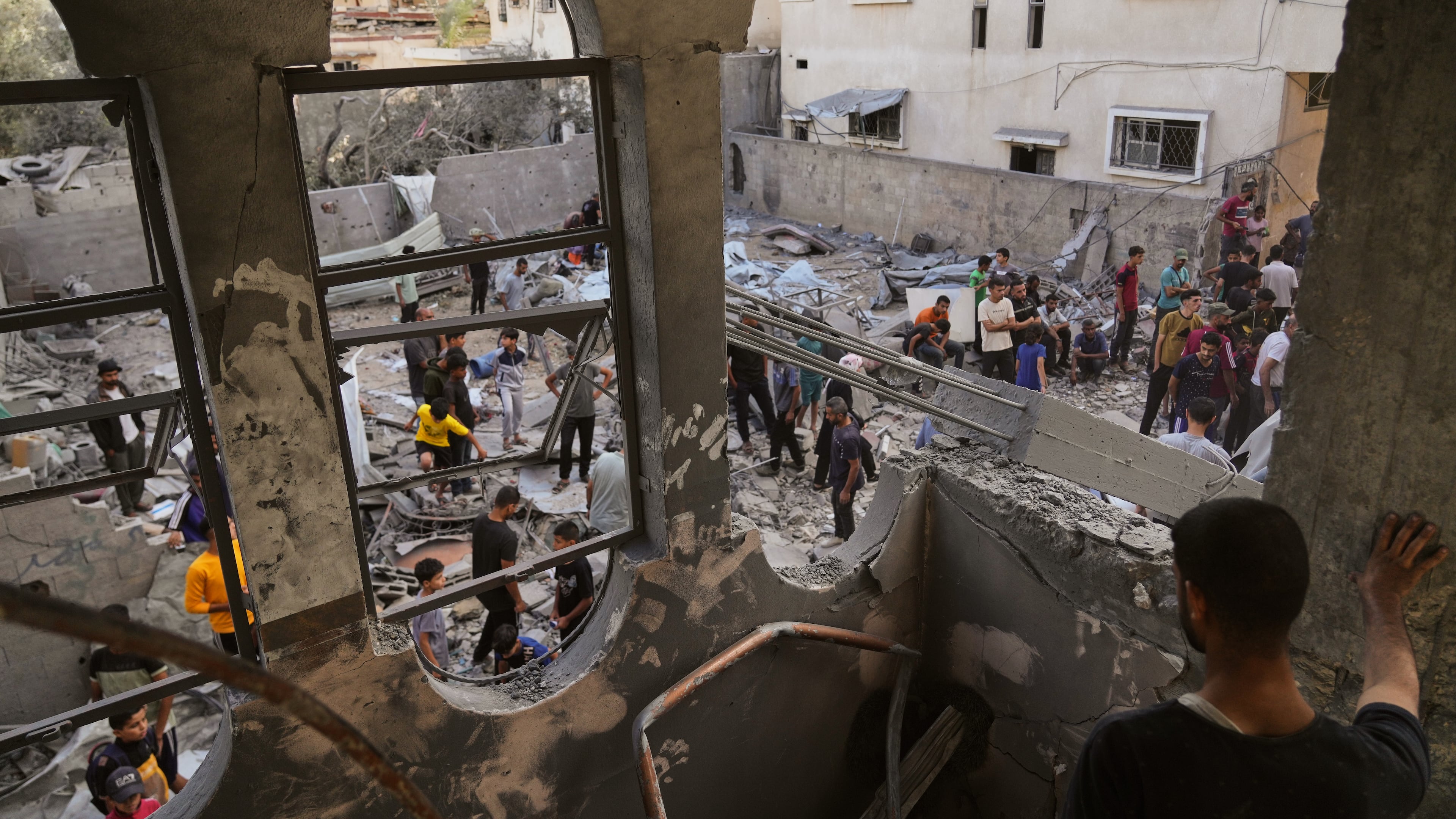 Palestinians survey the aftermath of an Israeli military strike on the Abu Dahrouj family home in Zawaida, central Gaza Strip, Thursday, Sept. 25, 2025. (AP Photo/Abdel Kareem Hana)