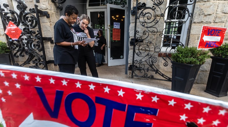 Cathy Anderson (left) goes over some last minute preparation with poll manager, Alex (right) at the polling place at the Park Tavern located at 500 10th Street NE in Atlanta on Tuesday, May 21, 2024. (John Spink/AJC)